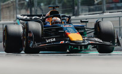 Red Bull Racing Formula 1 car on a race track, front-left view with prominent VISA and Red Bull logos.