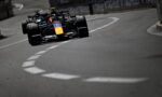 Red Bull Racing Formula 1 car rounds a tight city street corner on the race track.