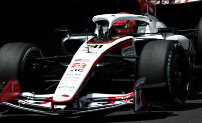 White and red Formula 1 race car from a low front-angle, sponsor logos visible on the nose and body.