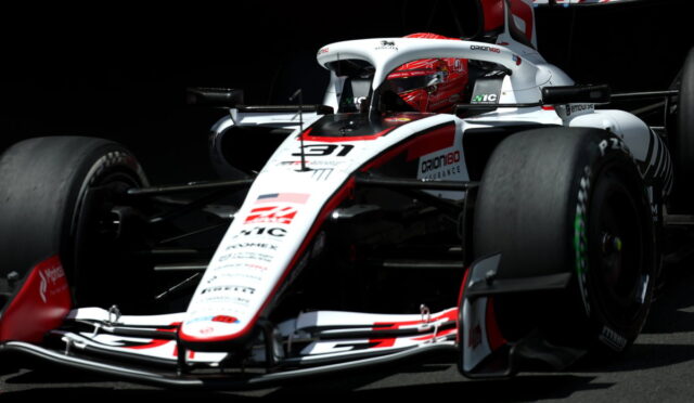 White and red Formula 1 race car from a low front-angle, sponsor logos visible on the nose and body.