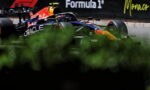 Red Bull Racing Formula 1 car on the Monaco track with Oracle branding and Formula 1 signage in the background