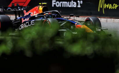 Red Bull Racing Formula 1 car on the Monaco track with Oracle branding and Formula 1 signage in the background