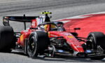 Ferrari Formula 1 car, number 44, rounding a track corner with sponsor logos visible (Shell, HP).