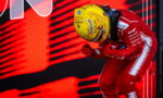 F1 driver in a red racing suit and yellow helmet leans forward in a victory celebration against a red LED backdrop simple, bold colors.