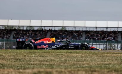 Formula 1 Red Bull Racing car on a race track with packed grandstands in the background.