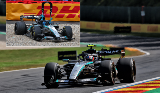 Mercedes F1 car on a race track navigating a left-handed curve, with a red-yellow advertising barrier in the background.