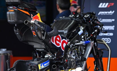 High-performance carbon fiber racing motorcycle on display with Red Bull and sponsor logos