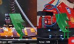 Two slot cars on a track, a McLaren (MON) on the left with a green rear wing and orange track pieces visible; a Ferrari (HUN) on the right with a blue cable and similar green wing, split screen view.
