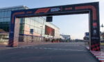 F1 finish arch over a road beside a glass building, with Formula 1 Gran Premio de España branding on it.