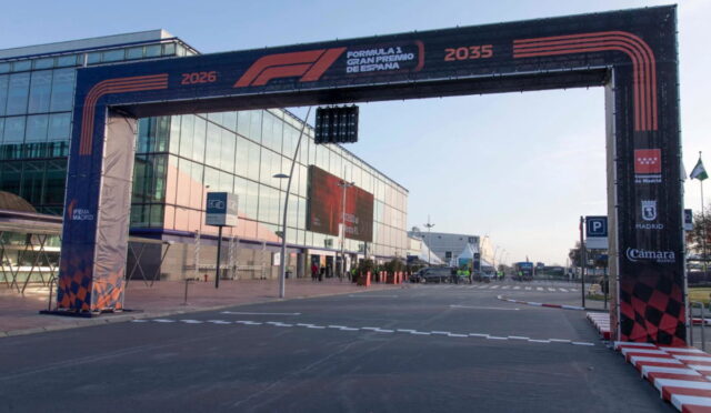 F1 finish arch over a road beside a glass building, with Formula 1 Gran Premio de España branding on it.