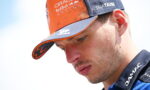 Close-up of a man in an orange and navy cap with Oracle Red Bull Racing and Alphatauri logos visible on the hat.