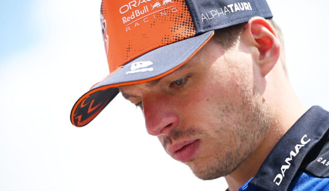 Close-up of a man in an orange and navy cap with Oracle Red Bull Racing and Alphatauri logos visible on the hat.