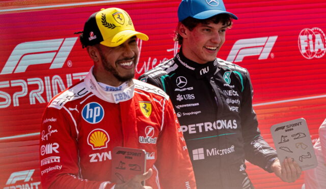 Two Formula 1 drivers pose on a podium, one in red Ferrari gear with a yellow cap, the other in black Mercedes gear with a blue cap, each holding a plaque against a red backdrop with F1 Sprint branding.