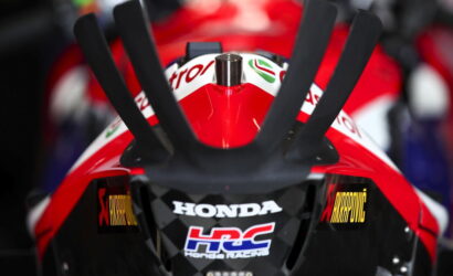 Front view of a red Honda racing motorcycle, featuring the HRC logo on the nose and racing decals.