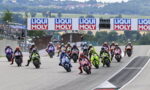 Group of motorcycle racers start a race on a track, banners reading LIQUI MOLY above them.