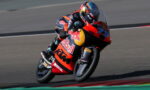 MotoGP rider on a Red Bull KTM racing bike, leaning into a turn on the track